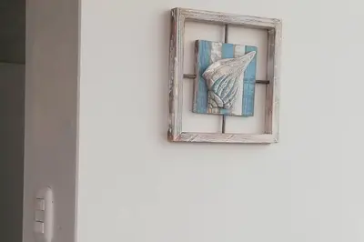 a window with a picture of a bird on a wall at L & P Apart Punta Hermosa in Punta Hermosa