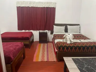 a room with two beds and a stuffed elephant on it at Mundo Viajero Saphy in Cusco