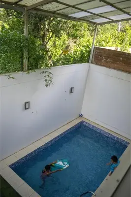 two people are swimming in a swimming pool at GOLDEN DOOR in La Merced