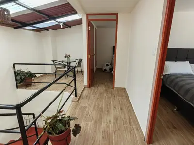 a small room with a bed and a table at Centro Cusco Inti in Cusco