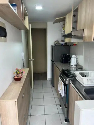 a kitchen with a stove and a counter top at Lindo Apartamento en Condominio Privado in Lima