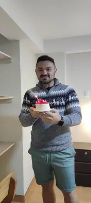 a man holding a piece of cake on a plate at Hotel Valle Andino in Cusco