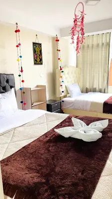 a hotel room with two beds with white sheets at Hotel Valle Andino in Cusco