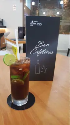 a drink sitting on a table next to a bar experience sign at Hotel Punta Rocas - Huacho in Huacho