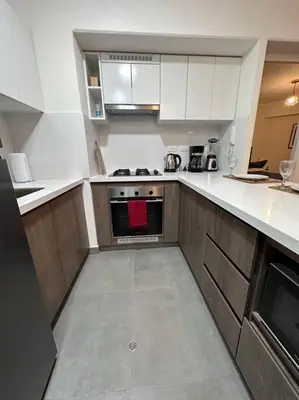 a kitchen with white cabinets and a stove top oven at 2BR 2BTH San Isidro Apartment in Lima