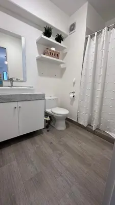 a white bathroom with a toilet and a sink at 2BR 2BTH San Isidro Apartment in Lima