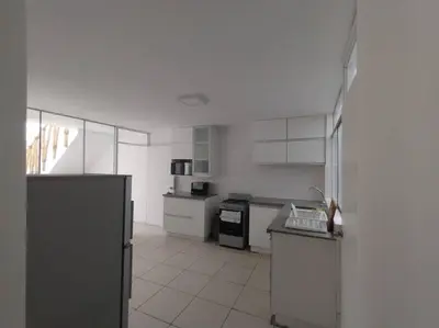 a white kitchen with a stove and a refrigerator at J&B Aparment 1 Punta Hermosa in Punta Hermosa
