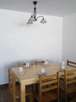 a wooden table with four chairs and a light fixture at J&B Aparment 1 Punta Hermosa in Punta Hermosa