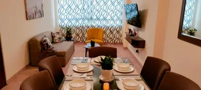 a dining room with a table and chairs and a window at Casa Bonita in Lima