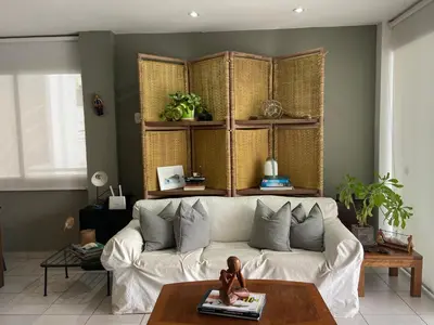 a living room with a white couch and a table at Watermanhouse, Punta Hermosa in Lima