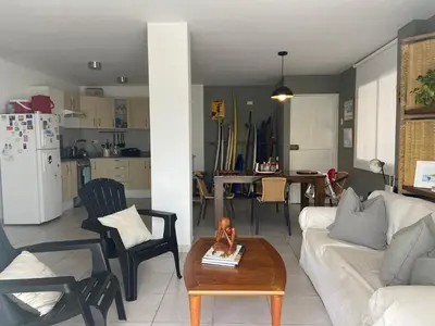 a living room with a couch and a table at Watermanhouse, Punta Hermosa in Lima
