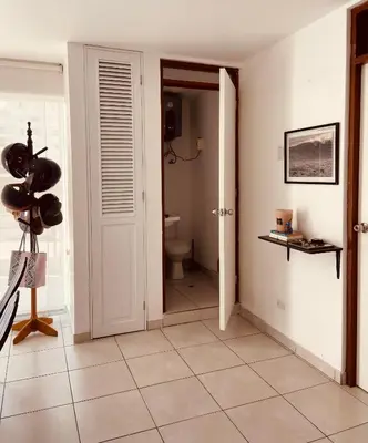 a hallway with a bathroom with a toilet and a door at Watermanhouse, Punta Hermosa in Lima