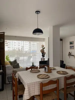 a living room with a table and a couch at Watermanhouse, Punta Hermosa in Lima