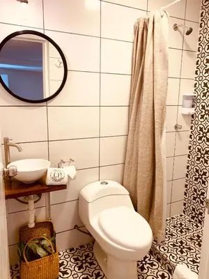 a bathroom with a toilet and a sink and a mirror at Casa Porta in Lima