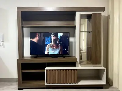 a flat screen tv sitting in a entertainment center at Moderno mini departamento de estreno in Lima