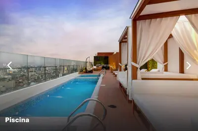 a swimming pool on the roof of a building at Moderno mini departamento de estreno in Lima