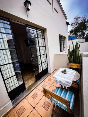 a small patio with a table and chairs on a house at Casaroma Hostels in Lima