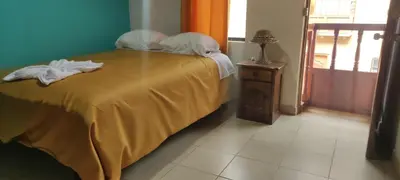 a bedroom with a bed with a yellow blanket at Casa D´Maria in Ollantaytambo