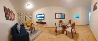a living room with a table and a dining room at Warmisitay H O M E in Lima