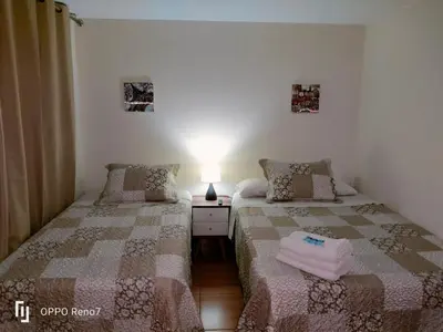 a bedroom with two beds and a lamp on a table at Warmisitay H O M E in Lima