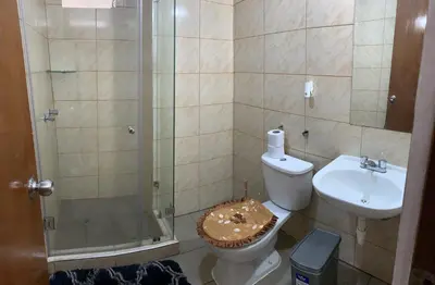 a bathroom with a shower and a toilet and a sink at Apartment 03 dormitorios San Miguel in Lima