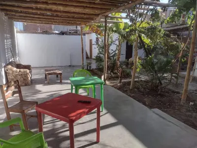 a group of chairs and a table in a room at 420 Route's Backpackers in Nazca