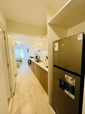 a kitchen with a stainless steel refrigerator in a room at Apartment with incredible view, pool and gym in Lima