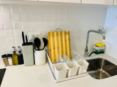 a kitchen counter with a dish drying rack next to a sink at Apartment with incredible view, pool and gym in Lima