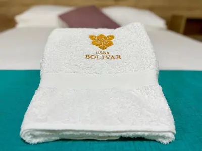 a white towel sitting on top of a bed at Casa Plaza Bolivar in Quillabamba