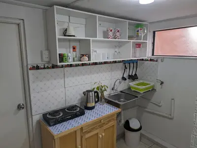 a small kitchen with a stove and a sink at Apartamento Privado, cerca al Centro Histórico de Lima in Lima