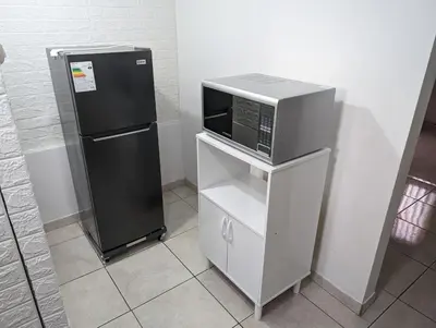 a microwave and a refrigerator in a room at Apartamento Privado, cerca al Centro Histórico de Lima in Lima