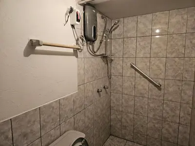 a bathroom with a toilet and a phone on the wall at COZZY APARTMENT IN AYACUCHO in Ayacucho
