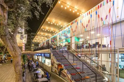a shopping mall with a staircase and a tree at Hermoso Apartamento Miraflores Central in Lima