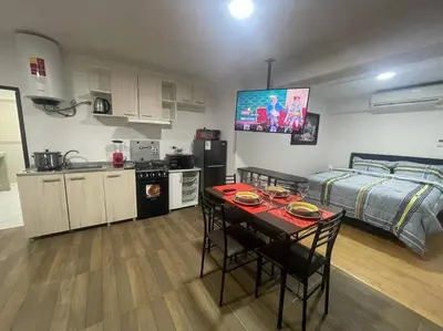 a room with a kitchen and a bed and a table at (25) Dpto con inmejorable ubicación en Miraflores in Lima