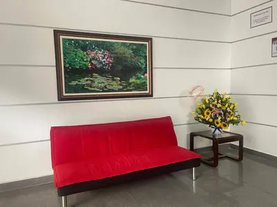 a red couch in a room with a painting on the wall at (29) Dpto Nuevo y Acogedor Miraflores in Lima