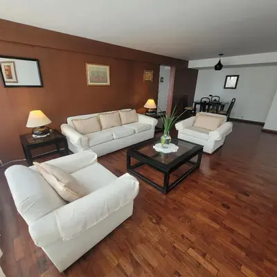 a living room with two white couches and a table at The Guest House 1 at the booming center of Miraflores, Lima - Peru in Lima