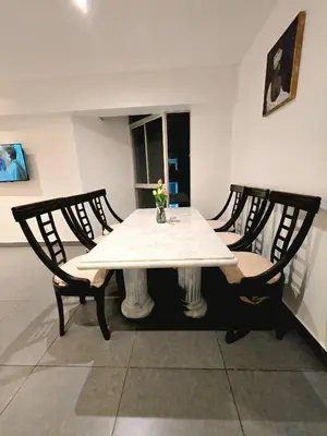 a table with two chairs and a white tablecloth on it at Duplex MyM in Lima