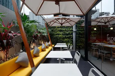 a restaurant with tables and chairs and umbrellas at Ikonik Miraflores in Lima