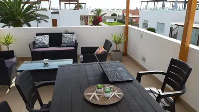a balcony with a table and chairs on a roof at Alquilo casa de playa Condominio Playa Azul cerca de Asia in Cerro Azul