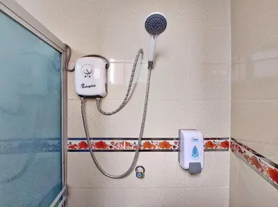 a shower in a bathroom with a shower head at Hospedaje Celerina & Elio in Lima