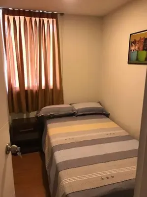 a small bedroom with a bed and a window at 821 Céntrico Departamento en Chorrillos in Lima