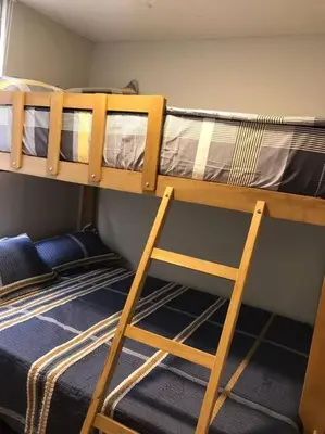 two bunk beds in a room with a ladder at 821 Céntrico Departamento en Chorrillos in Lima