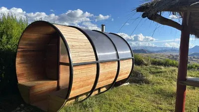 a wooden and black dome house in a field at Sky Dome Peru in Cusco