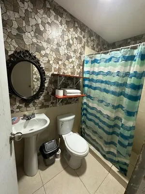 a bathroom with a toilet and a sink and a mirror at 595 Departamento en Chorrillos in Lima