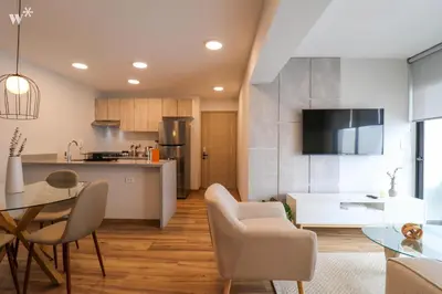 a kitchen and living room with a table and chairs at Colon by Wynwood House in Lima