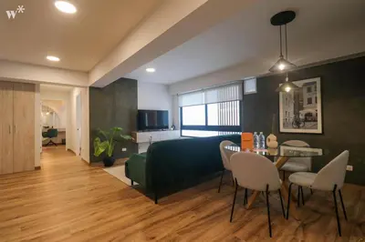 a living room with a bed and a table and chairs at Colon by Wynwood House in Lima