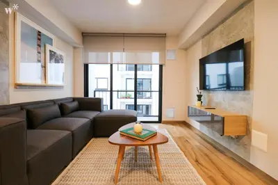 a living room with a couch and a table at Colon by Wynwood House in Lima