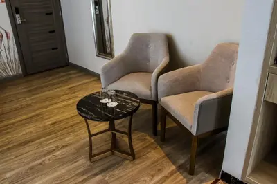 two chairs and a table with wine glasses on it at Gold Source Hotel in Lima