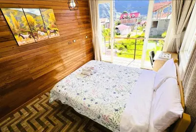 a small bedroom with a bed and a window at Colina Haus, casa vacacional Oxa in Oxapampa